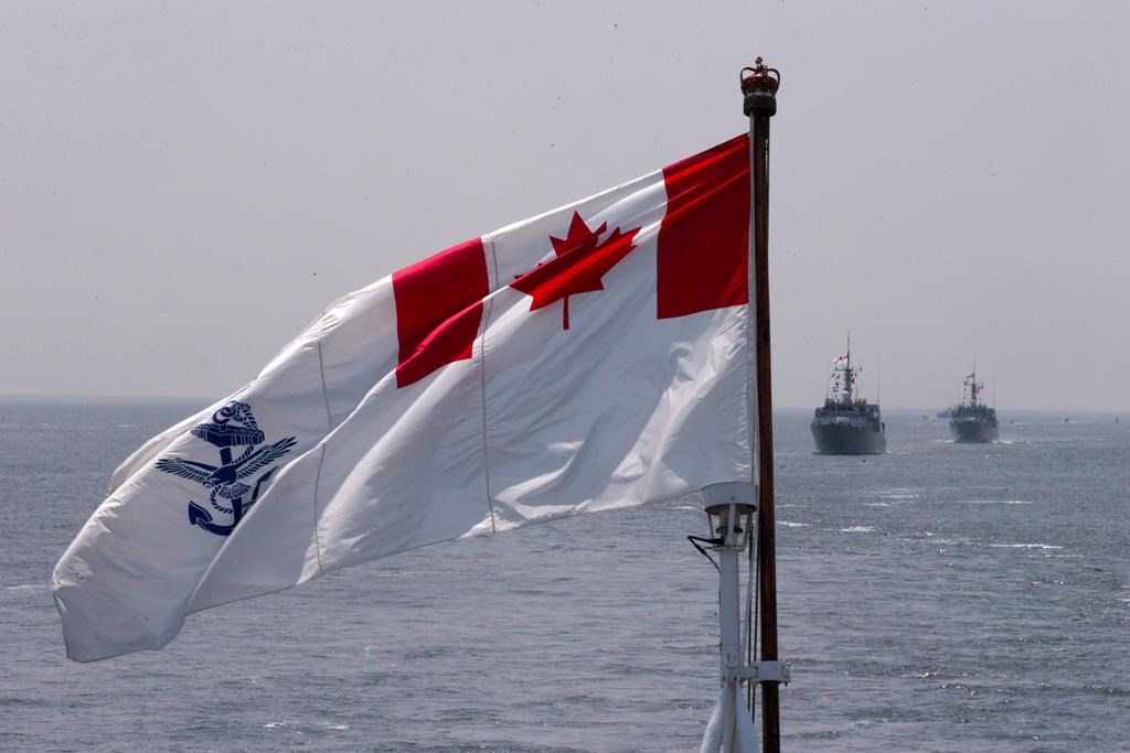 The Royal Canadian Navy Ensign flies during the Parade of Ships entering the New York Harbor, Wednesday, May 25, 2016. The Royal Canadian Navy says a sailor has died in the Bedford Basin after a boat capsized. THE CANADIAN PRESS/AP-Mary Altaffer.